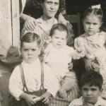 Enlargement-of-House-in-Monterrey,-Mexico-1945.-Pa,-cousin-Licha-at-top,-Ma-with-baby-Rudy.-Betty-next-to-Ma,-Al-next-to-Pa,-cousin-Carrue-on-step.